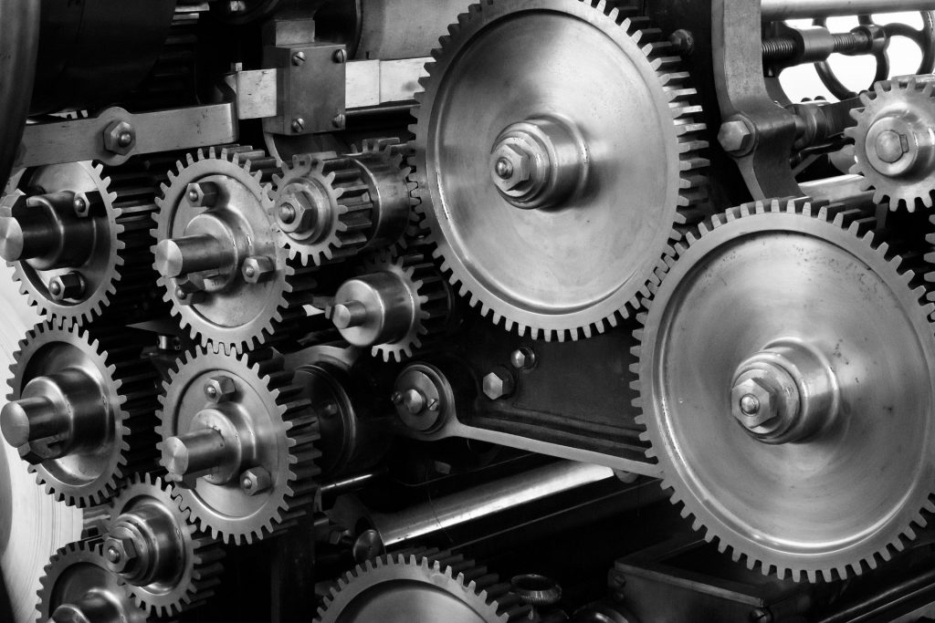 inside of a building machine with silver cogs.